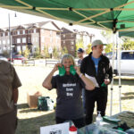 http://Tree%20Canada%20staff%20holding%20up%20garden%20gloves,%20smiling%20at%20the%20camera.