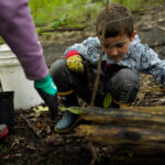http://Young%20boy%20planting%20a%20tree.