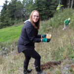http://Excited%20volunteer%20planting%20a%20tree.