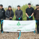 http://New%20York%20Fries%20volunteers%20posing%20in%20front%20of%20the%20National%20Tree%20Day%20banner.