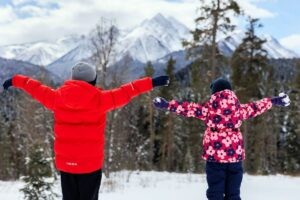 children arms extended enjoying nature